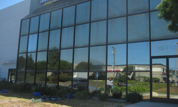 This is how performance glass, or exterior reflective glass, looks when neglected for years. Huntington Beach, CA