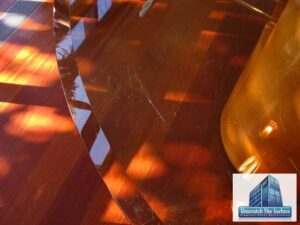 Closeup of glass scratches in table top near bevel before resurfacing. Bel Air, CA