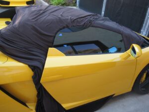 Fixing glass scratches on side window of yellow Lamborghini. Newport Beach, CA