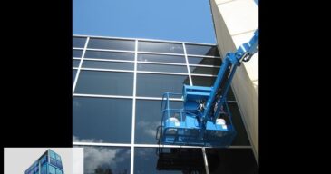 Glass scratch removal on tall hurricane glass curtain wall from JLG boom lift. Scratches visible towards top. Restoration project in Biloxi, MS