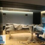 Getting scratches out of glass will create some dust. Cover everything. Be safe. Seattle, WA