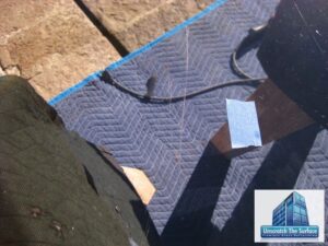 Visible deep scratch in glass dining room table top before grinding and scratch removal. Bel Air, CA