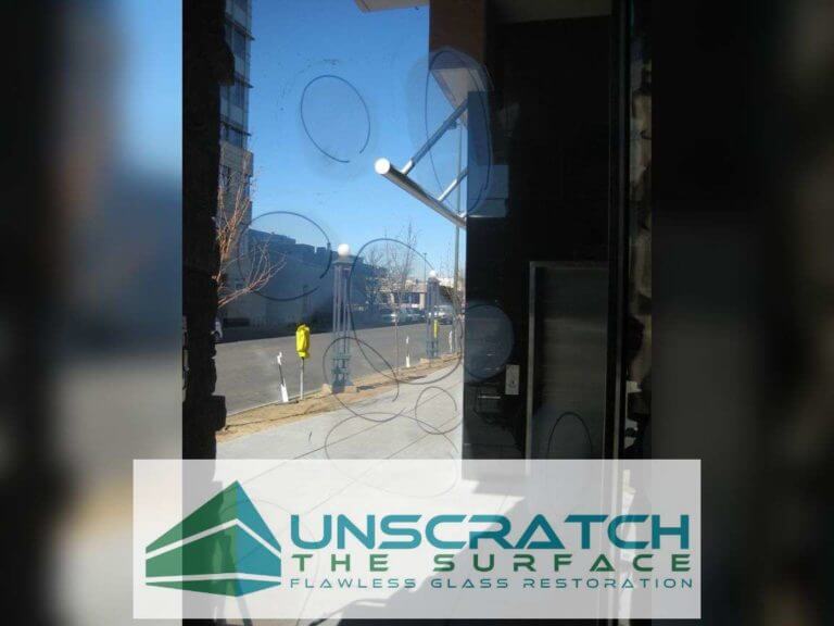 Highlighted scratches being removed from tempered door in Denver, CO at North Creek Residences