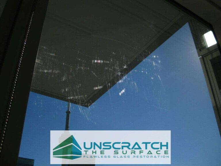 Shangri-La Toronto scratched tempered glass visible in sunlight with CN Tower in background