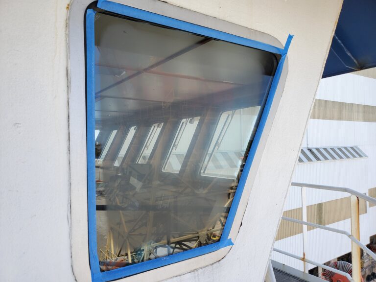 glass scratch repair Tampa FL - Liberty tugboat side window BEFORE scratches repaired