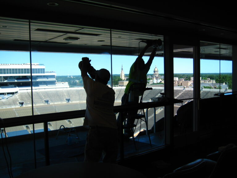 Union helpers polishing glass at Notre Dame commercial glass restoration project