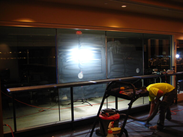 Cleaning dust on commercial glass restoration project at Notre Dame football stadium.